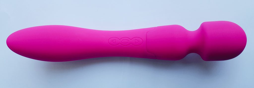 Feature photo for Aurora's Christmas Sex Toy Giveaway. An image of the Naught Passion G Spot Curve Vibrator on a blue background with pink paper confetti under and in front of the vibrator. Image has white snowflake dots over it and a blue clipart christmas tree in left bottom corner. It also has 'Christmas Giveaway' written across bottom of image.