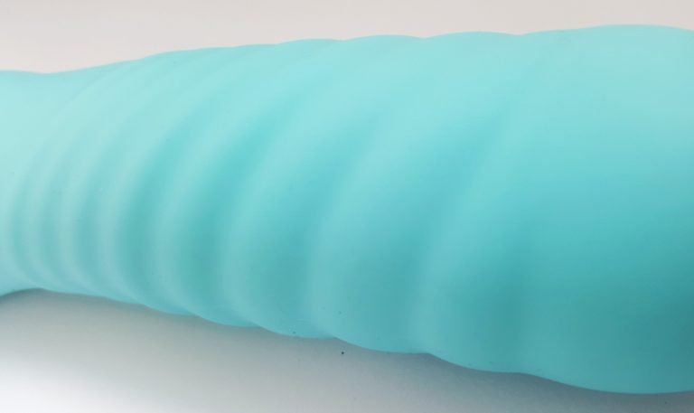 Image of the Naughty Passion Silicone G-Spot Curve Vibrator Packaging. Shows the vibrator peeking out of the black rectangular box.