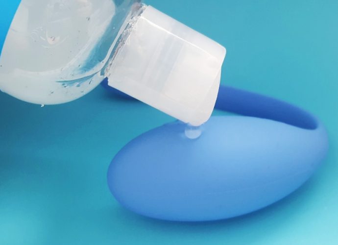 Feature photo of Sliquid lube being dripped onto the We Vibe Jive against a blue background.