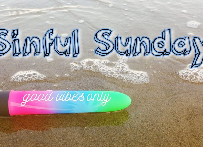 Photo of good vibe only vibrator on the beach with wave coming up to it. Photo says 'sinful sunday'