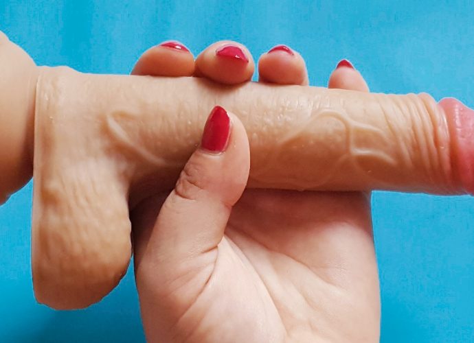 Feature photo for the Paloqueth Dual Density Dildo review. Hand holding the dildo over a blue background.