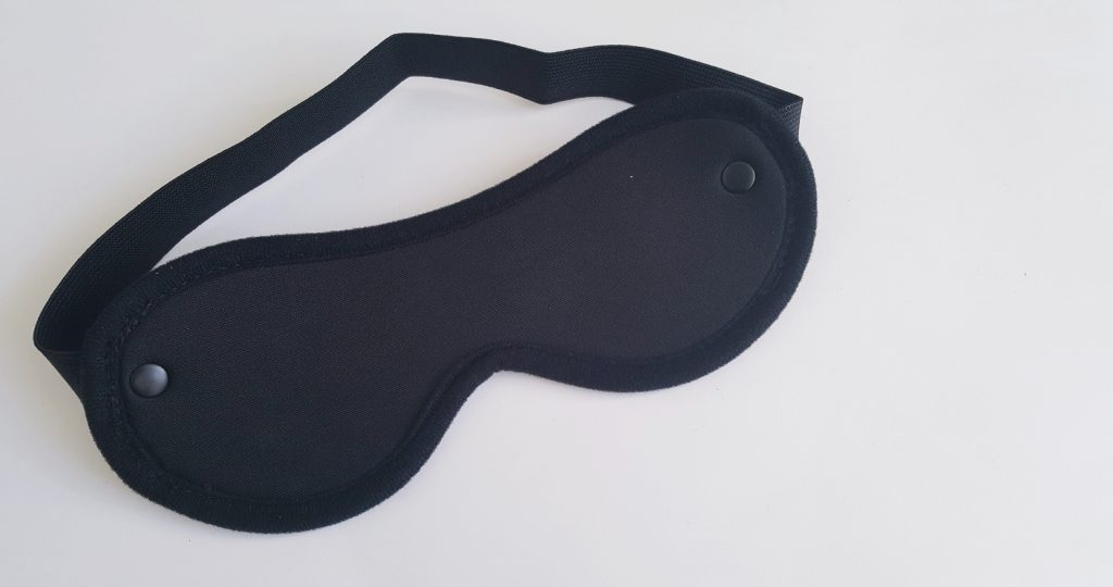Image of the Lovehoney All Tied Up Bondage Play Kit Blindfold. A standard black eye mask.