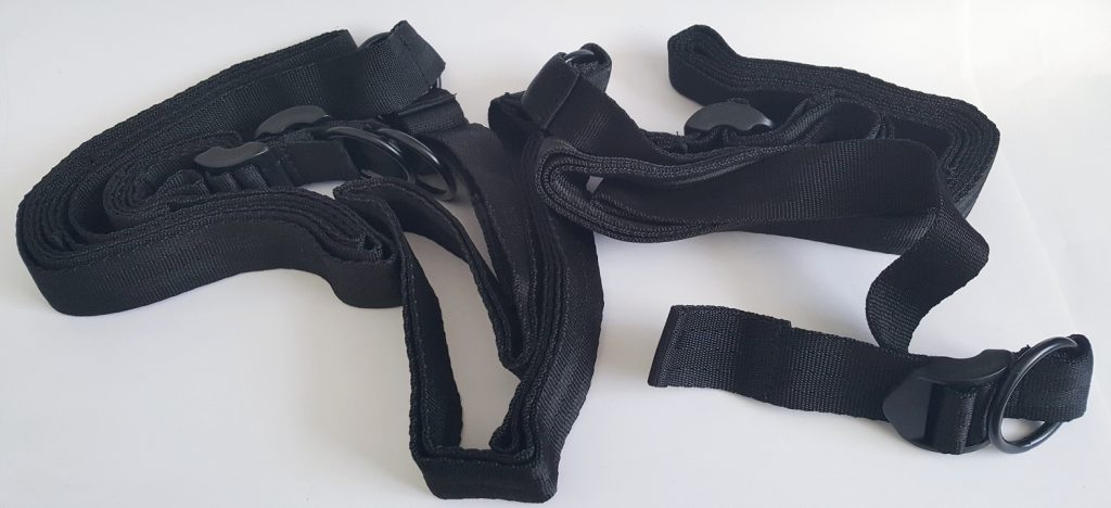 Image of the Lovehoney All Tied Up Bondage Play Kit Under-Mattress Restraints. Image shows the black straps heaped in a pile.