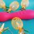 Feature photo for the Blush Novelties Real Nude Rollo Dildo Review. Dildo suctioned to bathroom tiles with my fingers pinching the tip.