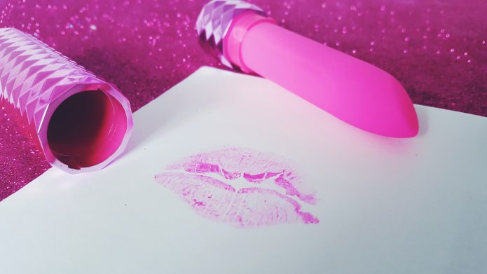 Feature photo for Lovehoney Lifelike Lover Ultra Realistic 7" Dildo review. Holding dildo over glittery blue background.